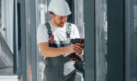 Working with windows. Repairman is indoors in the modern room. Working with windows. Repairman is indoors in the modern room.